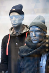 Male mannequin with warm shawl in a clothing store