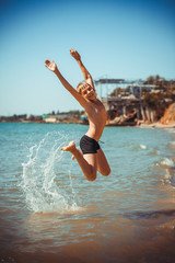 happy little boy in the sea