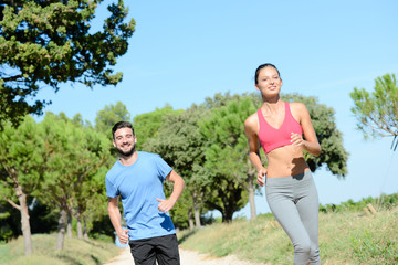 young healthy couple running outdoor in summer during a fitness exercise