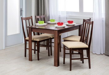 Fototapeta na wymiar Simple wooden dinning table and chairs in interior - studio ambi