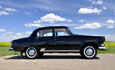 Fototapeta na wymiar Retro car. Black old auto on sky background