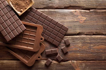 Deurstickers Chocolate on wooden wall background © digieye