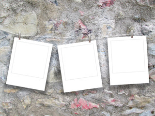 Three hanged square frames on weathered concrete wall background