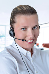 blondy beautiful girl with headphone in call center