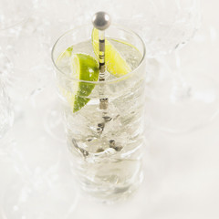 Glass of gin and tonic with ice and fresh sliced lime