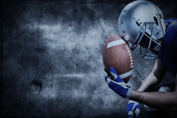 Composite image of american football player with ball against helmet © vectorfusionart