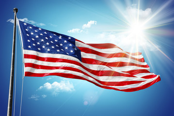 Fototapeta premium American flag in blue sky and sunshine background