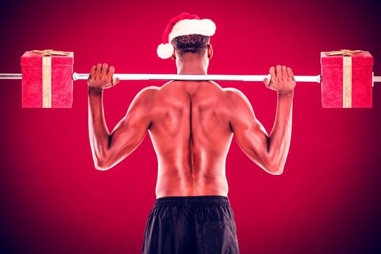 Composite image of shirtless fit man pushing up gifts