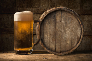 Beer barrel with  glass on table  wooden background