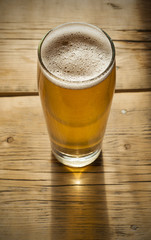 Beer barrel with  glass on table  wooden background