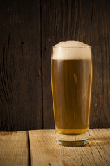 Beer barrel with  glass on table  wooden background