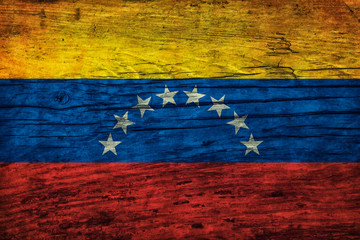 Vintage flag of Venezuela on a wooden surface