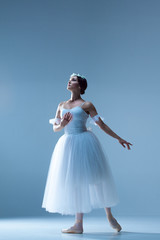 Fototapeta na wymiar Portrait of the ballerina on blue background