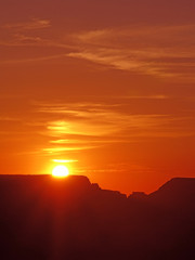 Orange skies with setting sun over mountain background copy space.