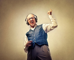 Man pretending to be playing an instrument while listening to music