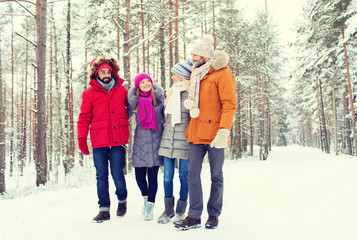 Fototapeta na wymiar group of smiling men and women in winter forest