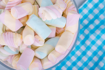 marshmallow candies in different colors on a gray background. top view. entertainment for children...