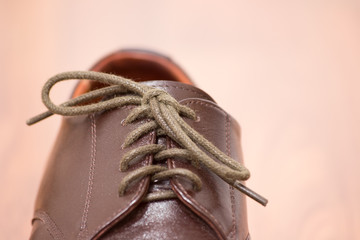 Close up view of a leather shoe, showing laces in selective focus