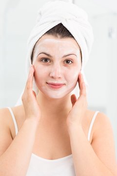 Spa female applying face mask