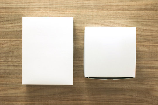 A empty(blank) white box on the desk(table) top view at the studio.