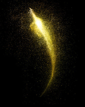 Explosion Of Gold Powder Isolated On Black