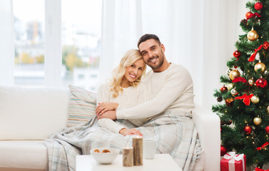 happy couple at home with christmas tree