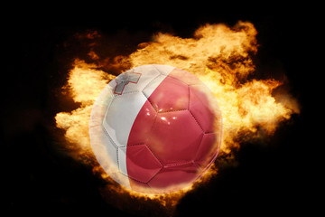 Naklejka premium football ball with the flag of malta on fire