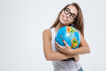 Smiling woman in glasses holding globe