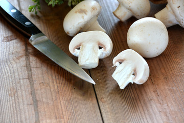 VARIOUS MUSHROOMS placed on a wooden table