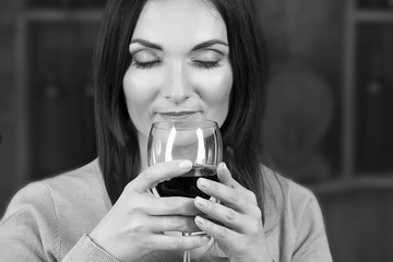 Portrait of beautiful woman drinking wine, black and white retro stylization