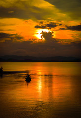 Naklejka na ściany i meble Silhouettes fishing boats evening at twilight time, Phuket, Thailand