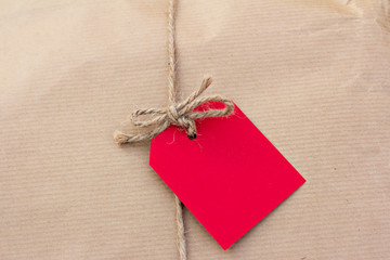 gift in kraft paper with red
