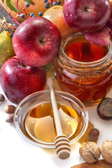 Honey, apples and autumn fruits on the white background