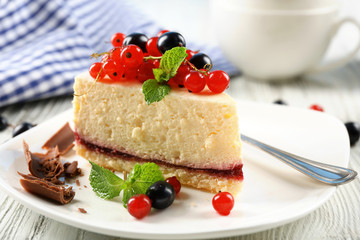 Delicious cheesecake with berries on table close up