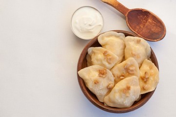 Dumplings with bacon in a clay bowl 
