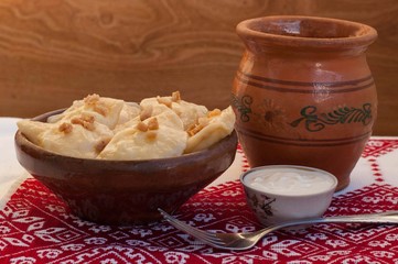 Dumplings with bacon in a clay bowl 