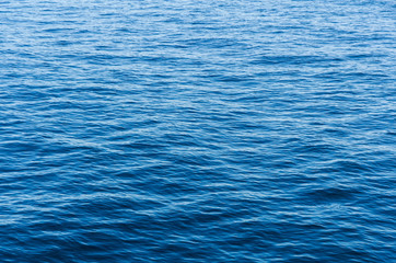 background of blue sea water surface with waves building intricate patterns