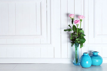 Home decor and roses on wooden background