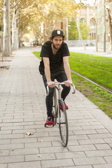 Fototapeta premium Hipster young boy riding his bike