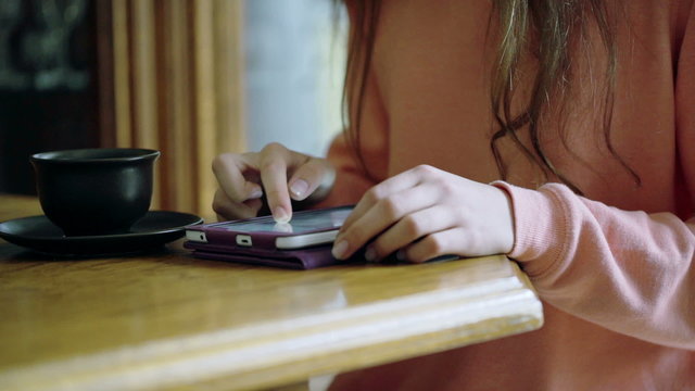 Woman scrolling websites on tablet and surfing on internet
