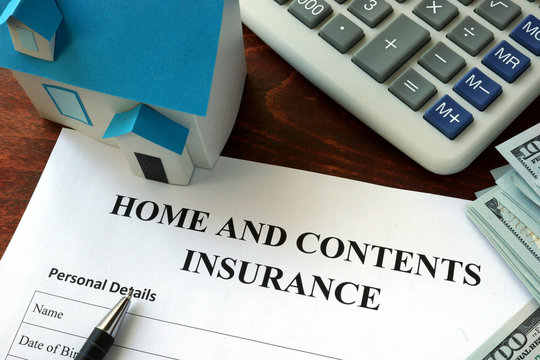 Home And Contents Insurance  Form And Dollars On The Table.