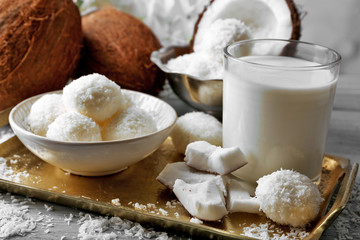 Homemade Candies in coconut flakes and fresh coconut on light background
