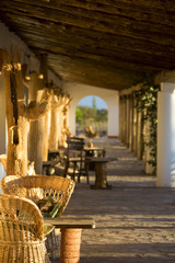Empty wicker chair located in the patio with sunrise light, Arge