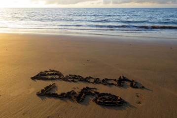 Beach Life written in sand, with the sea in the background
