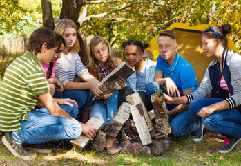 International teens setting up bonfire together