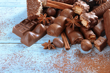 Chocolate sweets with powder on wooden background