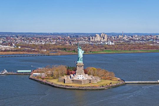 Aerial view of the Statue of Liberty with Downtown Brookyn in th