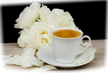 cup of coffee and white roses