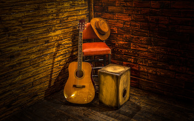 Acoustic instruments on small stage in bar