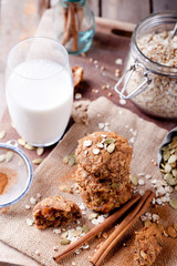 Oat and peanut butter cookies with pumpkin seeds,cinnamon,milk.